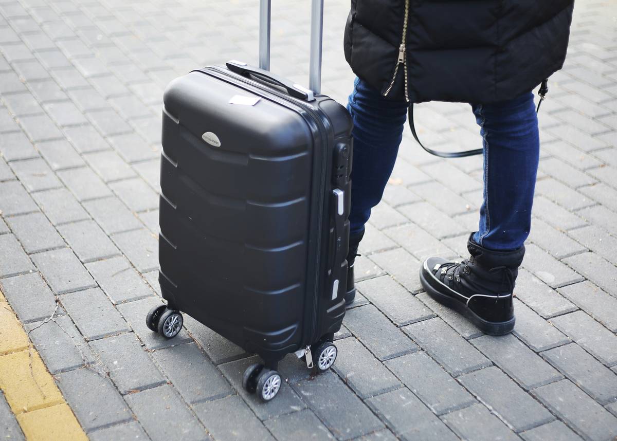 Stylish matte navy luggage in airport instagram pics with soft lighting and blurred background